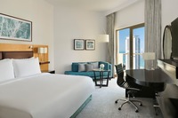 King bed, balcony, pool, amenities.