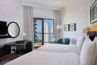 Twin bed, lounge, balcony, pool.