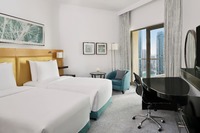 Twin bed, balcony, pool, amenities.