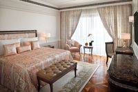 Elegant Versace room with city view.