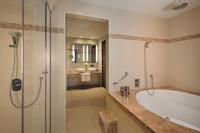 Spacious suite, city view, dining area.