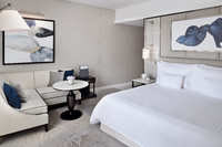King bed, skyline views, luxurious comfort.
