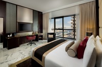 Spacious suite, balcony, city views.