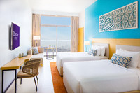 Two double beds, a balcony, and cable TV.