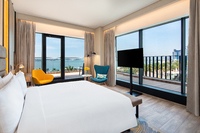 Beachfront corner room with balcony views.