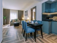 Separate bedroom and living room with dining table