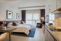 Studio with twin beds, kitchenette.