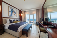 Expansive, mid-level, luxury king bed.